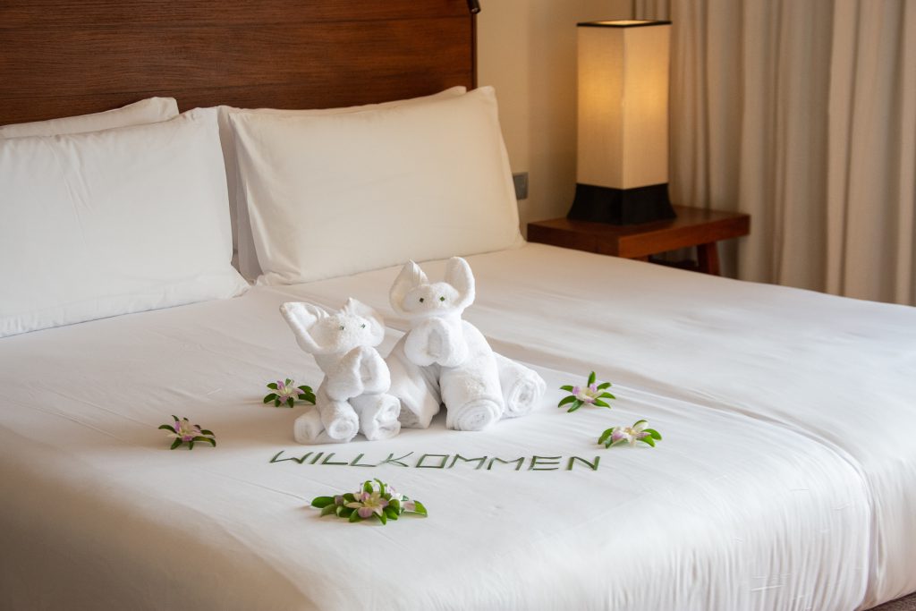 Phuket, Thailand, Paresa Resort, hotel room, hotel bed, bed, sheets, white, flowers, welcome